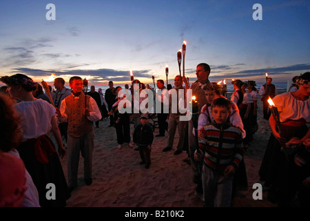 junge Menschen mit Fackel während Mittsommer Feiern am Strand von Jurmala Lettland Baltikum Stockfoto