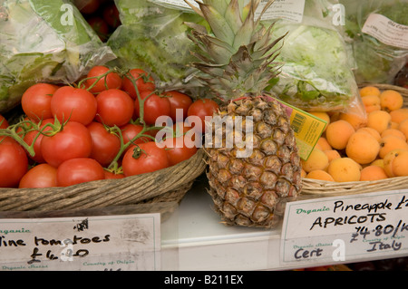 Bio-frische Lebensmittel auf Verkauf Rebe Tomaten Ananas und Aprikosen Stockfoto