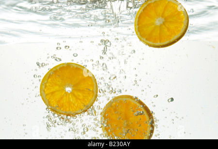 Scheiben von Orangen in Wasser mit bubbles Stockfoto