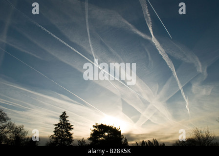 Mehrere Kondensstreifen von Flugzeugen am Himmel zeigen die Flugbahn über Midhurst, Sussex, UK, Sunrise Stockfoto