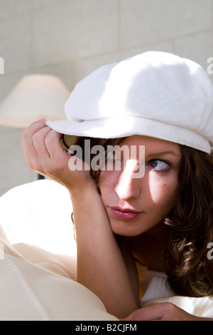 junge hübsche Frau mit weißer Kappe Stockfoto