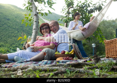 Ältere Mann umarmt eine reife Frau bei einem Picknick Stockfoto