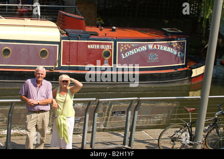 London, ältere Touristen-paar, gelangweilt, Leute zu beobachten in der Sonne durch das Wasserbus Hausboot, das Wasser Ouzel, am Camden Lock Market Stockfoto