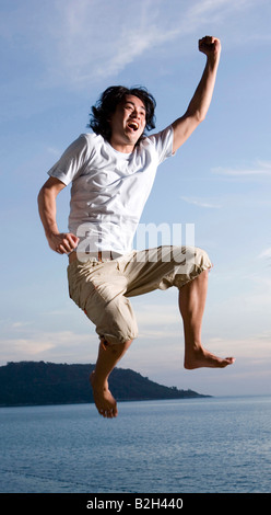 Niedrigen Winkel Blick eines jungen Mannes, springen, Phuket, Thailand Stockfoto