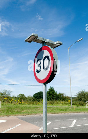 30 30 km/h Meilen pro Stunde Weg zu unterzeichnen, mit Lichtern an der Seite von der Straße auf einen sonnigen Tag Weitwinkel Stockfoto