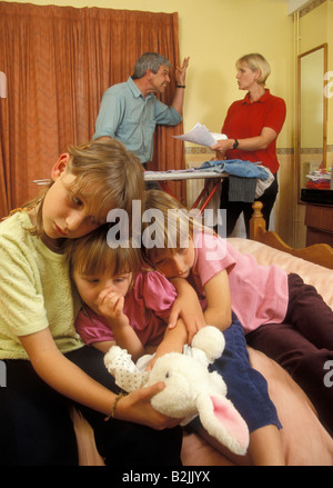 Eltern mit Argument vor drei Töchter, die in Angst zusammen gepresst werden Stockfoto