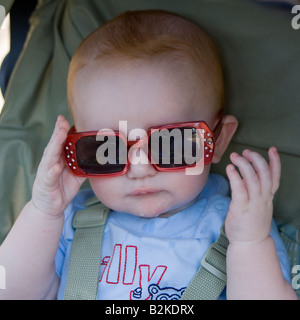 Männliches Baby mit großen dunklen Sonnenbrille Stockfoto