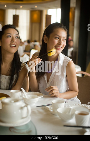 Zwei junge Frauen, die Dim Sum in einem Restaurant Essen Stockfoto