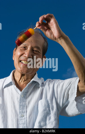 Porträt von einem senior Mann hält ein Eis und lächelnd Stockfoto