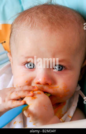 6 Monate altes Baby Spaß Essen Stockfoto