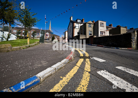 Unionist Farben gemalt auf den Straßenrand in The Fountain Bezirk von Londonderry, County Derry, Nordirland Stockfoto