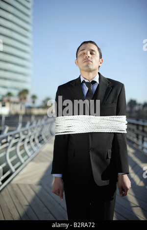 Business-Mann gefesselt mit Seilen im freien Stockfoto