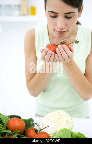 Frau riechen Reife Strauchtomaten, close-up Stockfoto