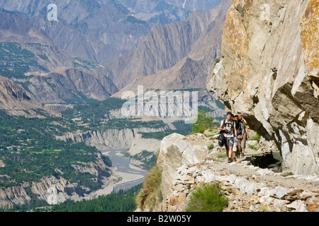 Wanderer auf einen unsicheren Weg in den Bergen oberhalb von Karimabad in Nordpakistan das Hunza-Tal Stockfoto