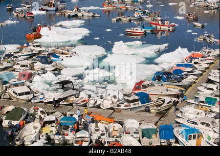 Inuit-Boote und Eisberge in Illulissat Hafen auf Grönland Stockfoto