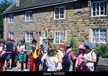 Kinder besuchen Pest Cottages Eyam Derbyshire leuchtend bunte Kleidung große Pest 1665 England UK Besucher Stockfoto