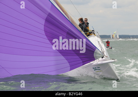 in Windrichtung Segeln J122 asymmetrische Segel Satz Segeln Cowes Woche Isle Of Wight-Crew auf der Backbordseite Stockfoto