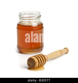 Glas Honig mit drizzler Stockfoto