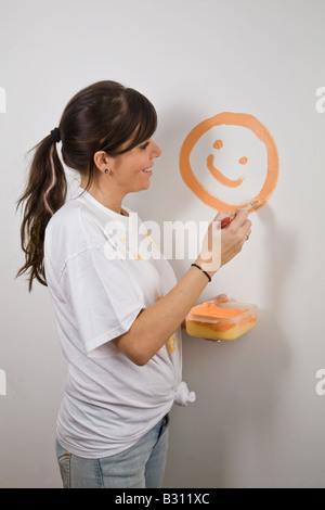 Junge Frau malt ihre Wohnung Stockfoto