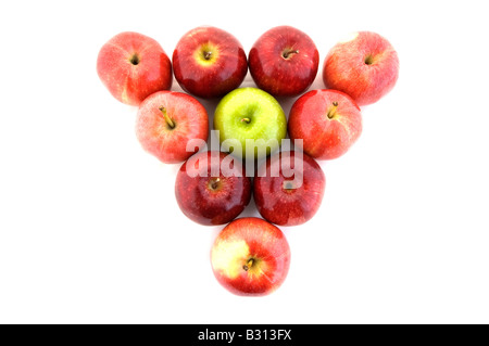 Ein grüner Apfel in einem Dreieck von roten Äpfeln Stockfoto