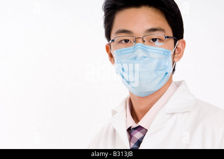 Junge asiatische Arzt in schützenden Gesichtsmaske Stockfoto