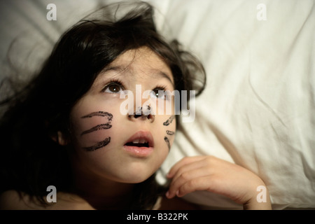 Fünf-Jahres-altes Mädchen mit des Vortages erwacht Gesicht malen. Sie spielte eine Katze in einer Schulaufführung und wollte es entfernen Stockfoto