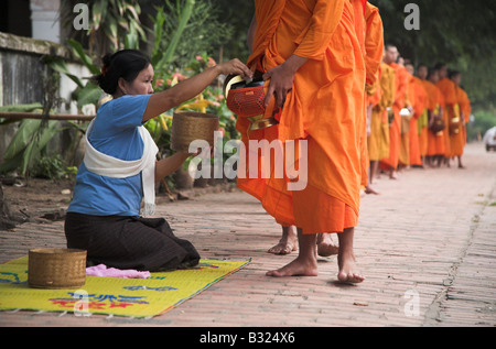 Lao Mönche empfangen Morgen Almosen in der Weltkulturerbe Stadt Luang Prabang in Laos. Stockfoto