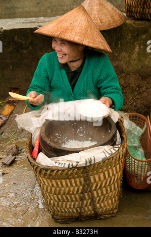 Eine glückliche vietnamesische Frau lacht beim Verkauf von Reis in Bac Ha Markt Nordvietnam Stockfoto