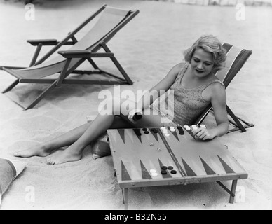 Frau spielt Backgammon am Strand Stockfoto