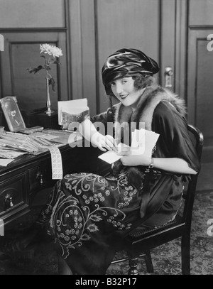Porträt der Frau am Schreibtisch mit Buchstaben Stockfoto