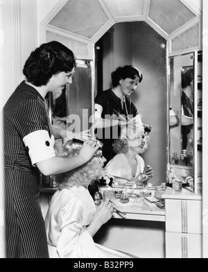 Frau, die ein weiteres Womans Haar kämmen Stockfoto
