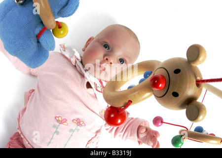Babymädchen spielen mit Trapez-Spielzeug Stockfoto