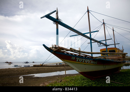 Ein Fischerboot in Reparatur liegt am Strand in Mansalay, Oriental Mindoro, Philippinen. Stockfoto