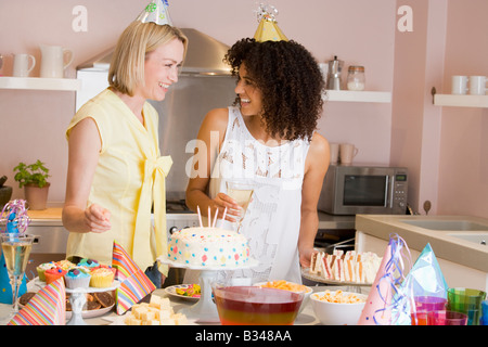 Zwei Frauen auf Party Essen Tisch lächelnd stand Stockfoto