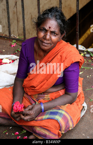 Eine Frau verkauft Blumen außerhalb der Stadt in Bangalore, Indien. Stockfoto