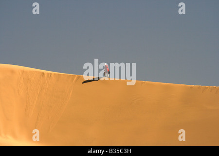 Einsamer Mann zu Fuß auf einer Sanddüne In Akachaker Tassili Ahaggar Sahara Wüste Algerien Stockfoto