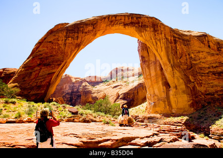 Besucher, die den natürlichen Sandstein Bogen am Rainbow Bridge National Monument Utah zu fotografieren Stockfoto