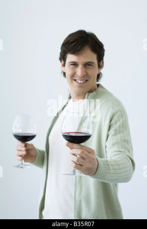 Mann, zwei Gläser Wein, hielt man in Richtung Kamera Stockfoto