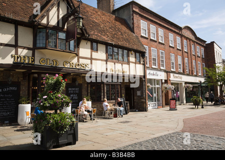 Das alte Kreuz Public House mit Menschen sitzen draußen auf der Fußgängerzone in der Innenstadt. Chichester West Sussex England UK Stockfoto