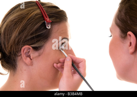 Junge Frau, die ein neues Gesicht Stockfoto