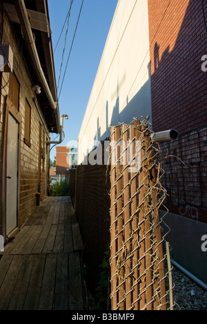 Aufgerollt temporäres Fechten sitzt in einer Gasse hinter Neubau in West Lafayette, Indiana Stockfoto
