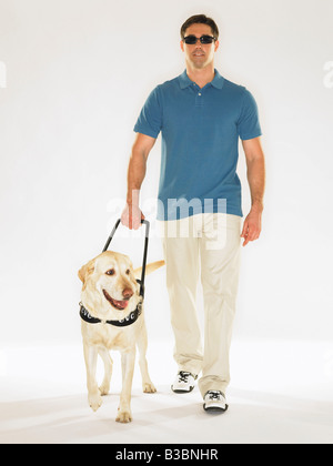 Mann zu Fuß mit Blindenhund Stockfoto
