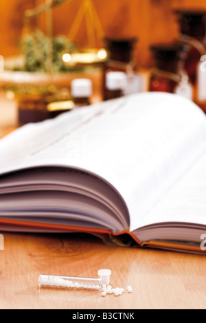 Homöopathisches Mittel vor homöopathischen Buch, Nahaufnahme Stockfoto