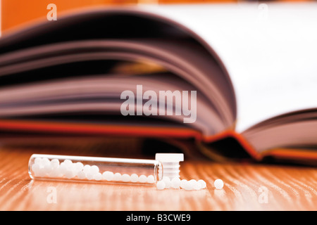 Homöopathisches Mittel vor homöopathischen Buch, Nahaufnahme Stockfoto