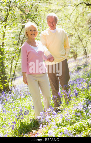 Paar zu Fuß im Freien halten Hände Lächeln Stockfoto