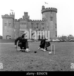 Die Beatles März 1964 John Lennon und George Harrison spielen Krocket auf dem Gelände des Dromoland Castle in Irland Stockfoto