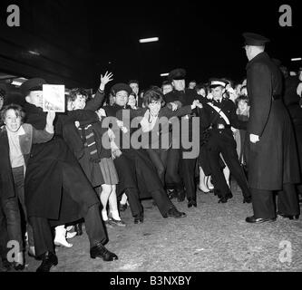 Pop Gruppe zurückhalten der Beatles November 1963 Polizei Fans und Massen, die darauf warten, einen Blick auf ihre Idole in East Ham erhaschen Stockfoto