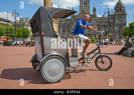 Tommy Braun, Reiten seine touristische Rikscha Fahrrad auf dem George Square Glasgow Schottland Stockfoto