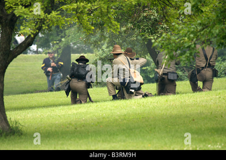 Soldaten der Konföderierten und Union antreten während einer Schlacht im Feldlager Civil War Reenactment Stockfoto