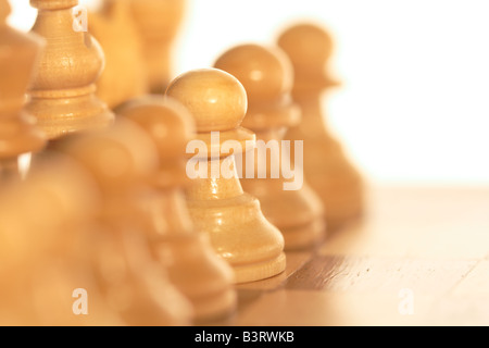 weiße Holz Schachfiguren, isoliert auf weiss mit Bokeh aus der Rubrik Focus. ein Bauer im Fokus Stockfoto